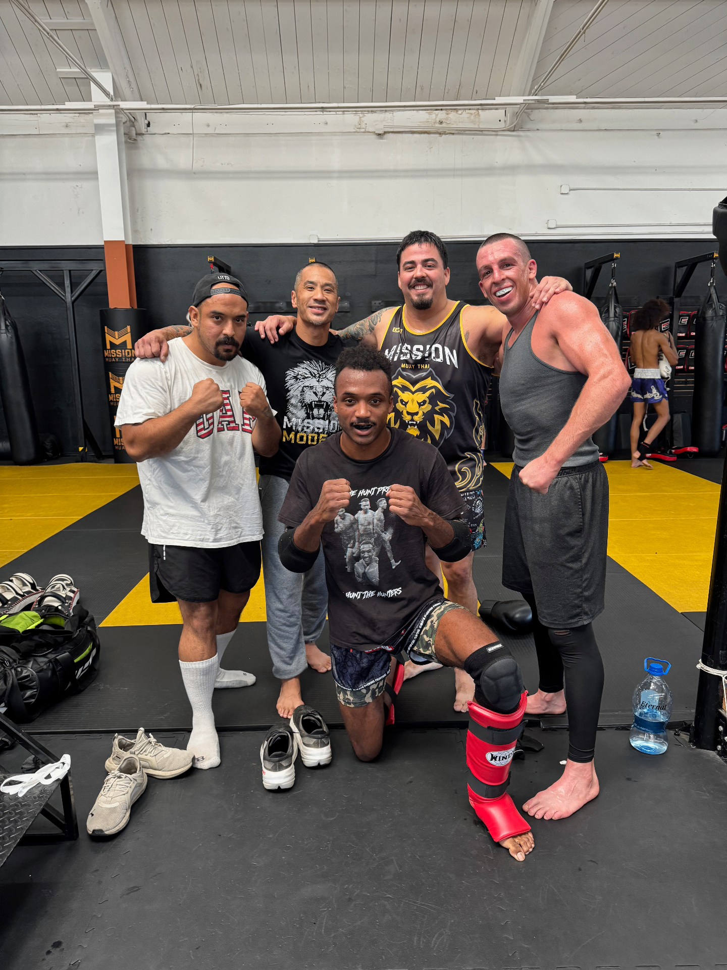 Clayton with fighters inside a Muay Thai gym